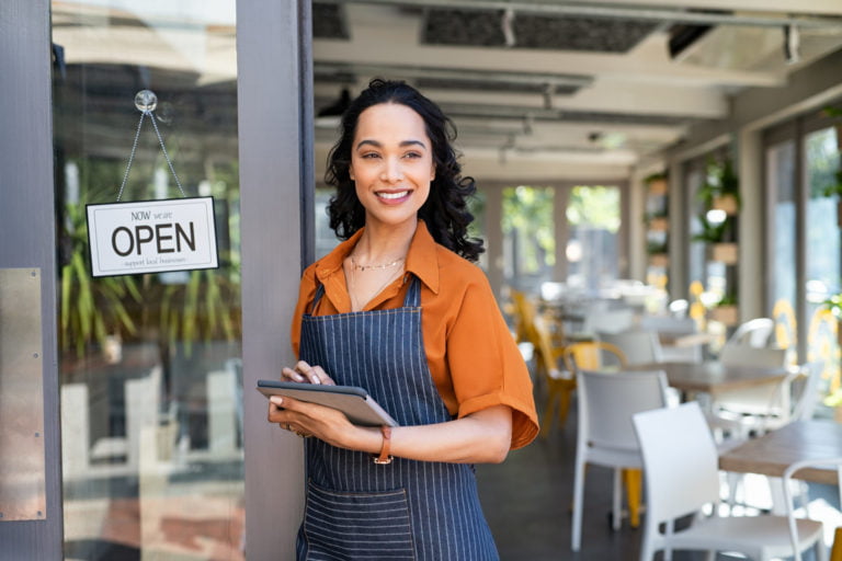 Small business entrepreneur at cafe entrance