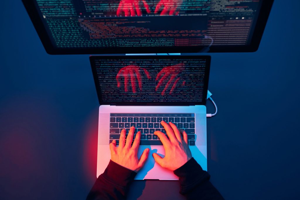 Man using computer and programming to break protection. Cyber security threat. Cyber attack